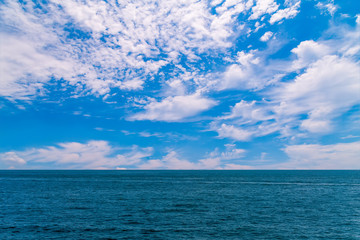 Naklejka na ściany i meble Blue sky, white clouds and the sea