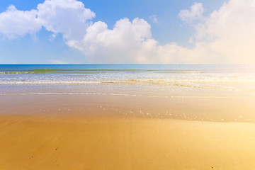 The sea and the beach under the blue sky and white clouds