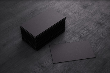 Blank template black Business Cards on black wooden background. 3D rendering.