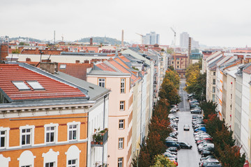 Obraz premium View from high point to the street with buildings, road and parked cars on it in Berlin in Germany.