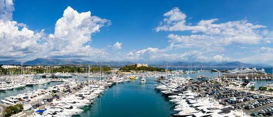 Panorama from Port of Antibes with old fort centered and mountains in background