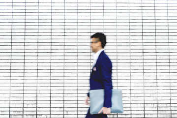 Businessman holding file walking outdoor