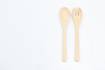 Wooden spoon and fork on white background