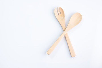 Wooden spoon and fork on white background