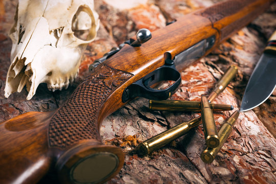 Hunting equipment on old wooden background