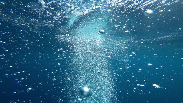 Air bubbles rise to the top, from the seabed by the underwater