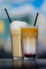 Latte with whipped cream and milky berry cocktail with blackberries and caramel