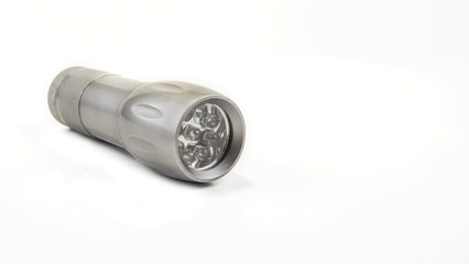 Small home pocket led flashlight in hand on the white