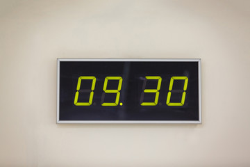 Black digital clock on a white background showing time 9 hours 30 minutes