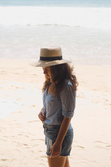 Girl in a hat on the beach 