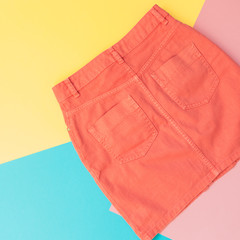 orange denim skirt for woman. pastel minimal, flat lay. summer and spring fashion concept