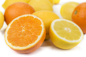 Fresh oranges and lemons on the white background
