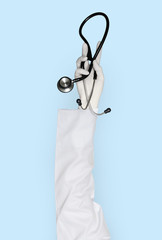 Hand with glove holding stethoscope