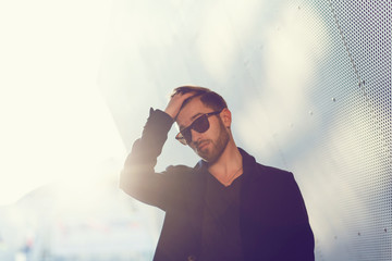 Style guy. Fashion man standing in urban setting