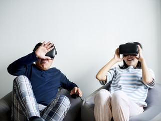 Couple using VR playing game