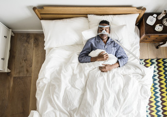 Man sleeping with an anti-snoring mask
