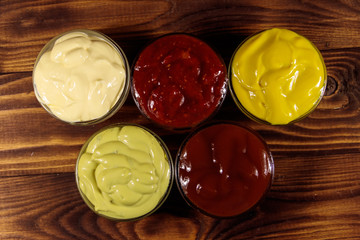 Set of sauces on wooden table