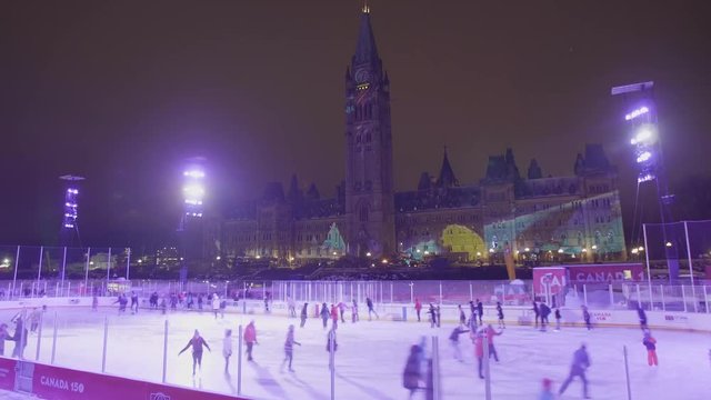 Time Lapse of People Ice Skating at Parliament in Ottawa with Northern Lights Show in Background