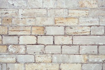 Fototapeta premium Part of a uneven stone wall with cement