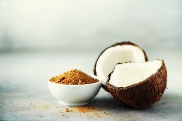 Coconut palm brown sugar and half of coconut fruit on grey concrete background. Copy space