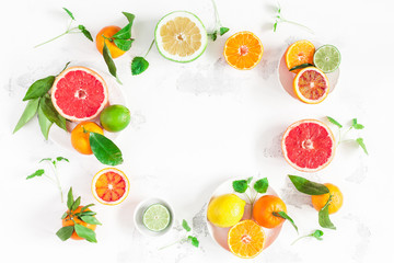 Fruit background. Colorful fresh fruits on white table. Orange, tangerine, lime, lemon, grapefruit. Flat lay, top view, copy space
