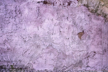 Grunge wall of the old house. Textured background. Plaster hue Ultra Violet