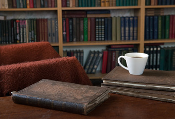 Sweet moments of relaxation with books and a cup of coffee. Vintage books, glasses, chair, library