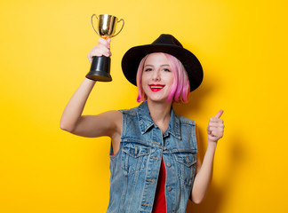 girl with pink hairstyle with winner trophy
