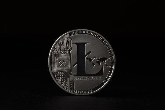 Silver Bitcoin coin on black background. Bitcoin cryptocurrency.