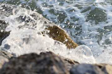 ocean waves crashing on the rocks, slow shutter speed shot for water movement