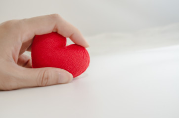 Red heart in hand isolated white background.