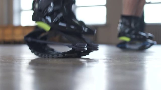 Close up of legs in kangoo jumping session. Training in the gym.