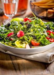 Green salad served on the plate.