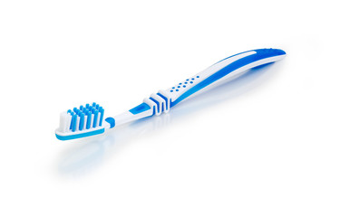 White and blue toothbrush on a white matte surface