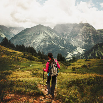 Woman hiking through mountains