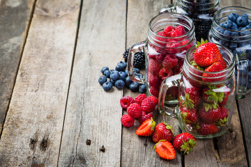 Berries in glass jars - homemade jam, smoothie, low fat dessert
