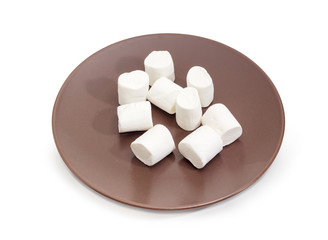 White marshmallow on a brown dish