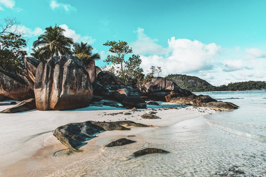 Idyllic tropical island beach with rock formation