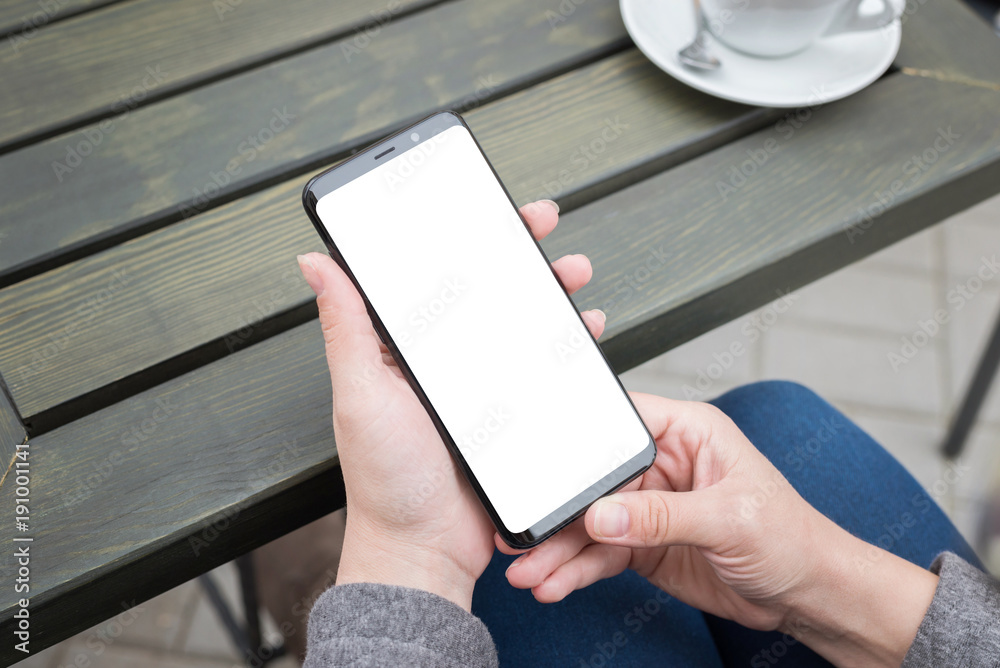 Aufkleber new modern smart phone in woman hands. isolated screen for mockup, app or responsive web site presen