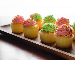 Pink and green cupcakes with sprinkles