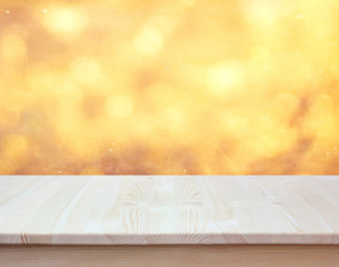 Empty countertop on blurred Golden background.