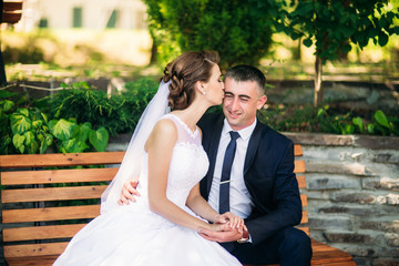 Bride and groom siting on the bench