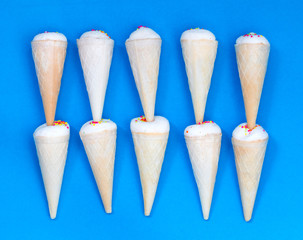 Small ice cream cone on a blue background.