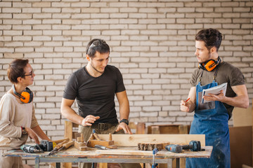 Students in woodwork training course with professional