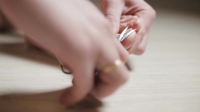 Man cutting toenails with scissors. Male cut toenails on foot. Toenails with fungal infection 