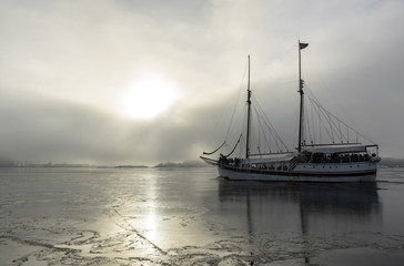 Fototapeta premium Sailing ship in foggy sea landscape