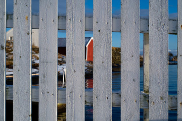 A white fence by the norwegian coast in winter
