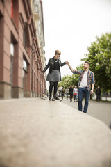 Fototapeta na wymiar happy loving couple walking down the street of a big city