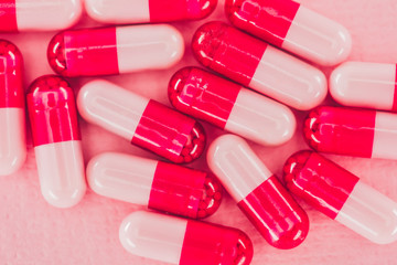 close up view of pills on pink backdrop