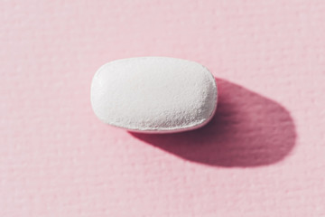 close up view of medicine on pink surface
